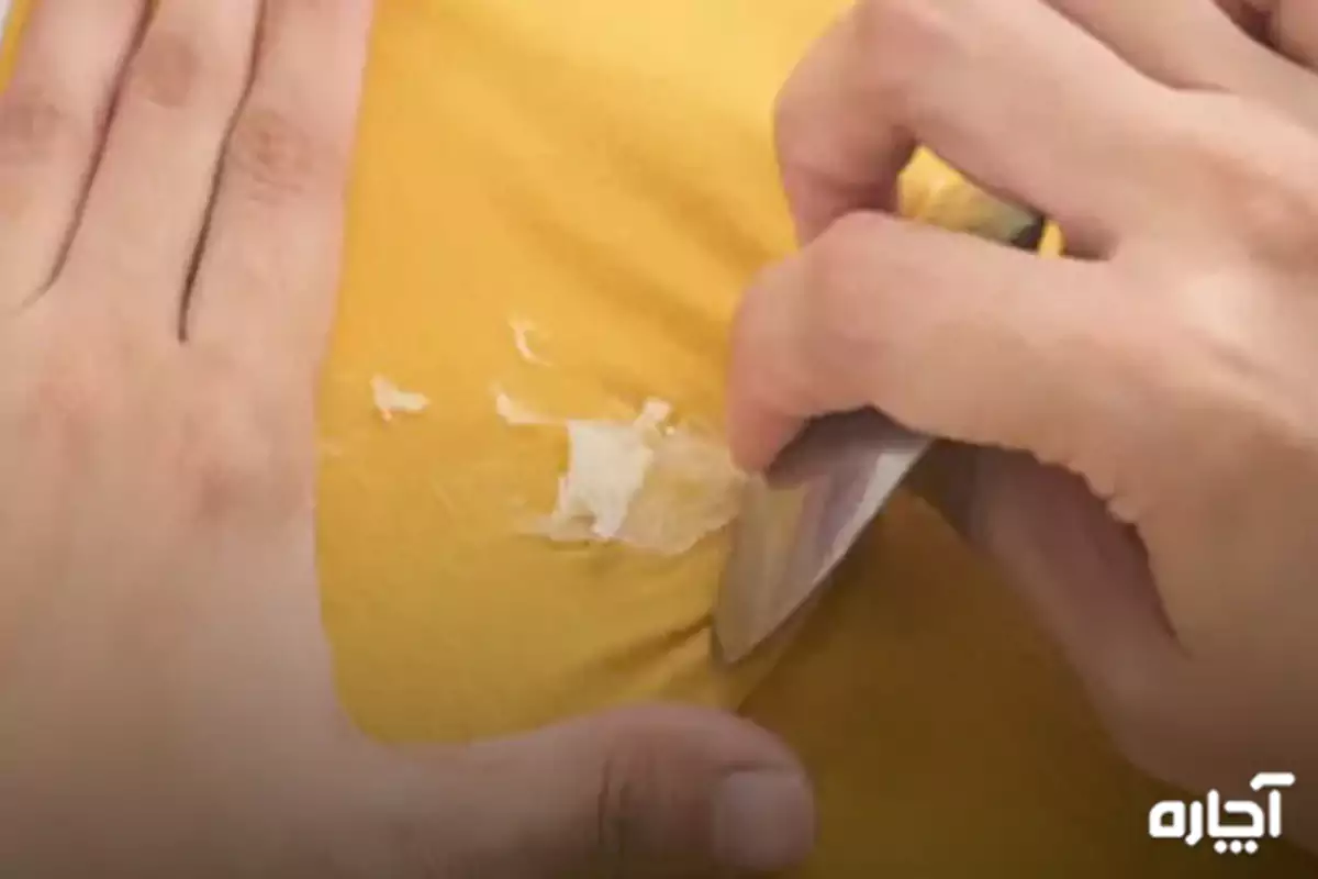 Scraping the glue from the fabric